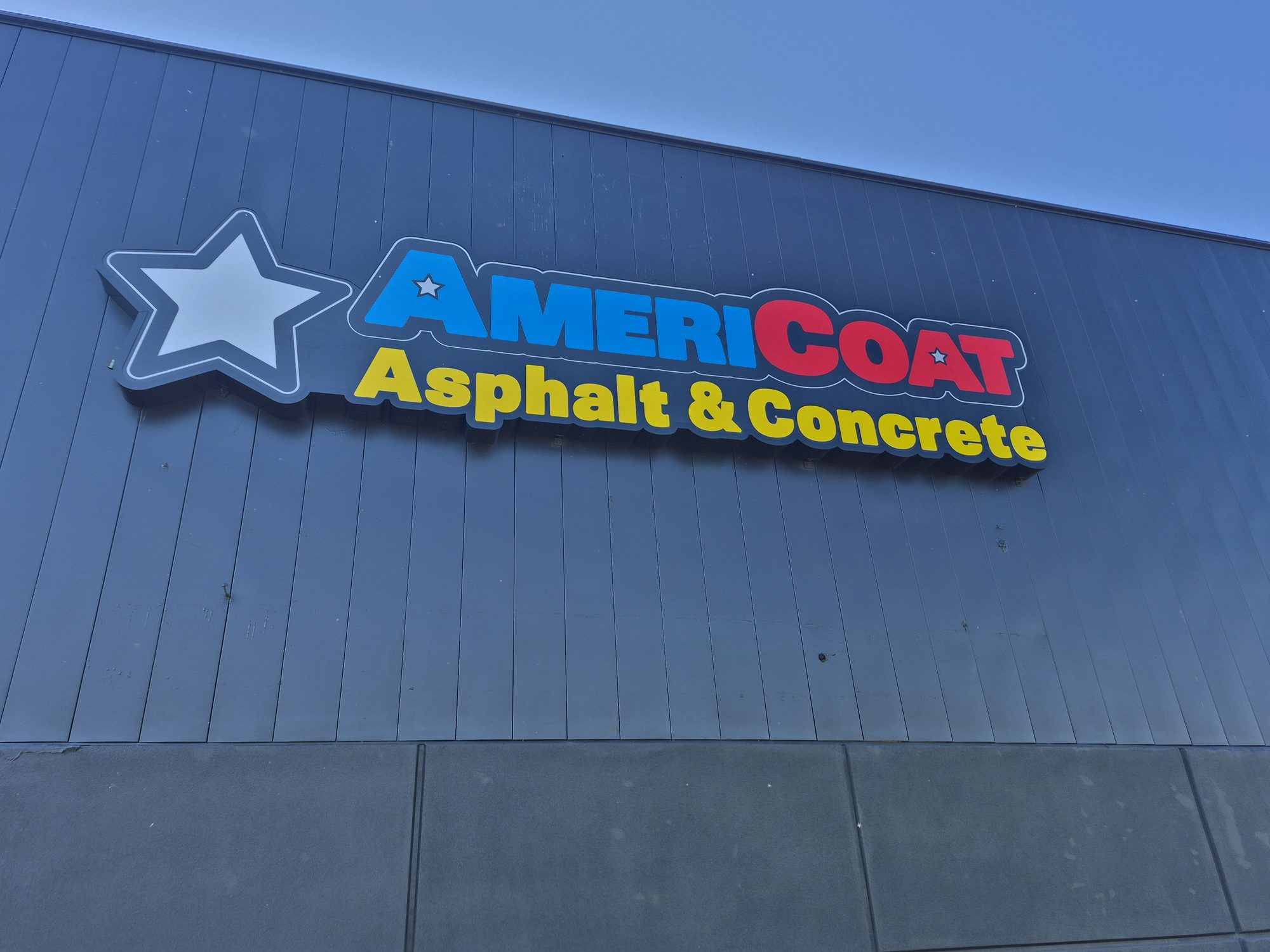 Channel letters with logo on metal facade