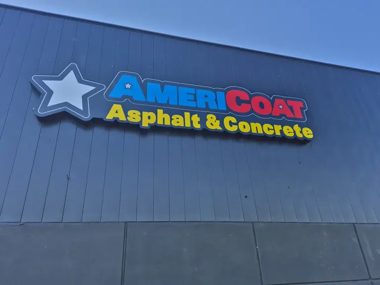 Channel letters with logo on metal facade